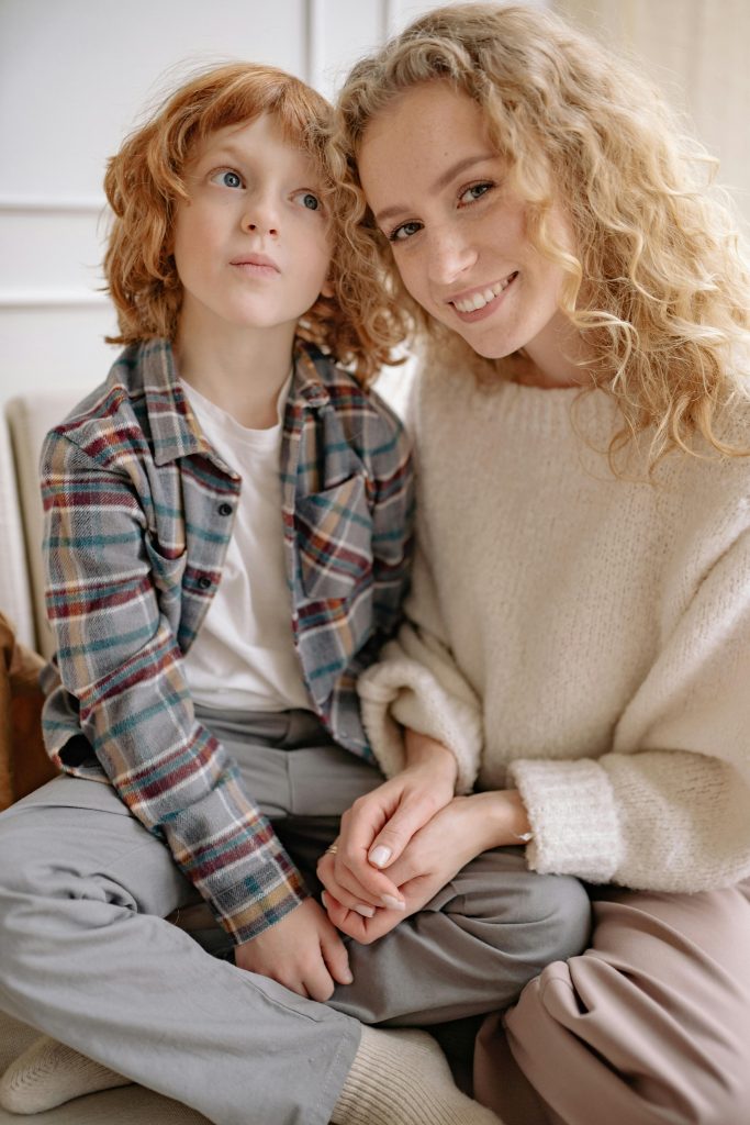 A mother and son sharing a warm, happy moment indoors, showcasing family love.